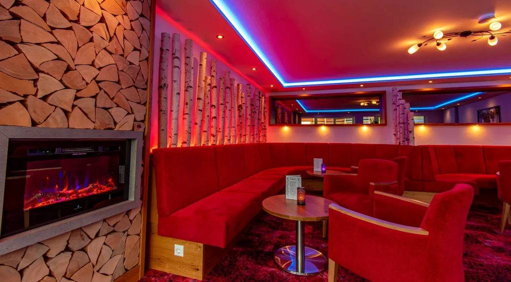 Wellnesshotel Hohenrodt, reception and lounge with fireplace and birch trunks for a warm, inviting atmosphere