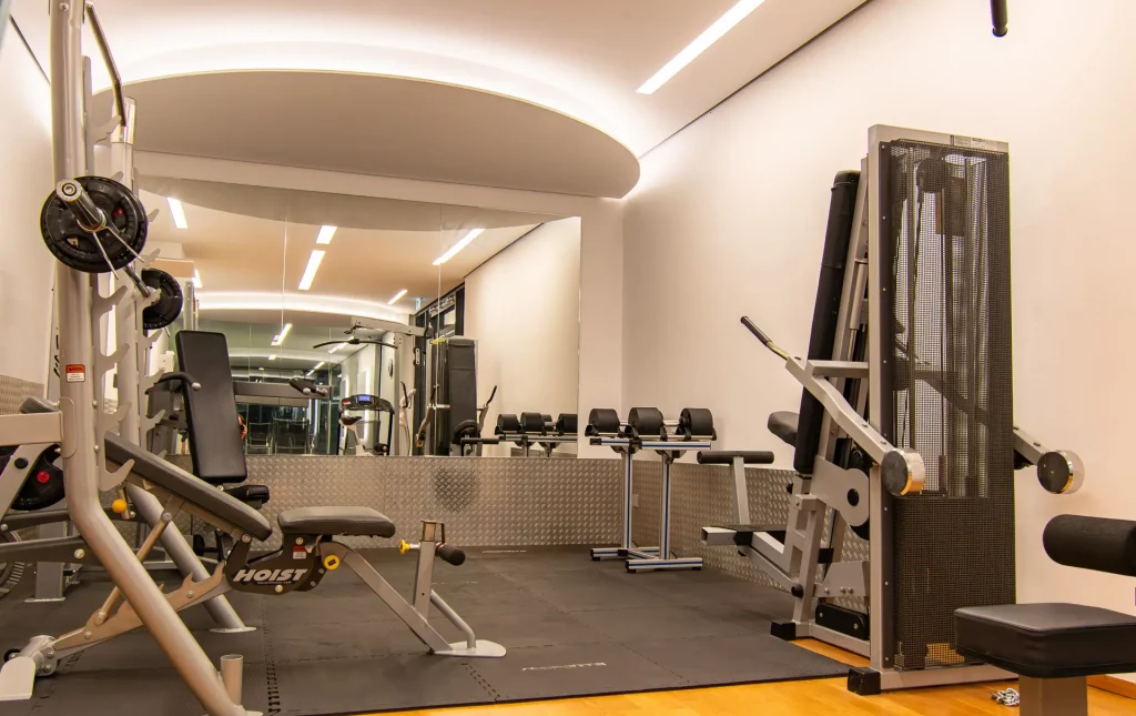 Wellnesshotel Hohenrodt, fitness room with dumbbells and modern training equipment for a complete workout experience