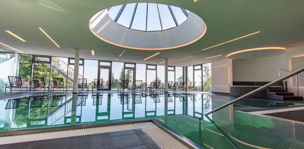 Wellnesshotel Hohenrodt, wellness pool area with indoor pool, daylight and a glass dome for a light-flooded and relaxing ambience