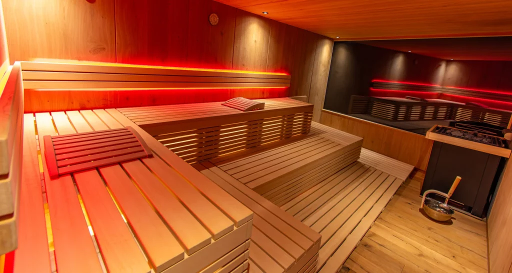 Wellnesshotel Hohenrodt, sauna area with outdoor sauna, equipped with red LED lighting for an atmospheric and relaxing atmosphere