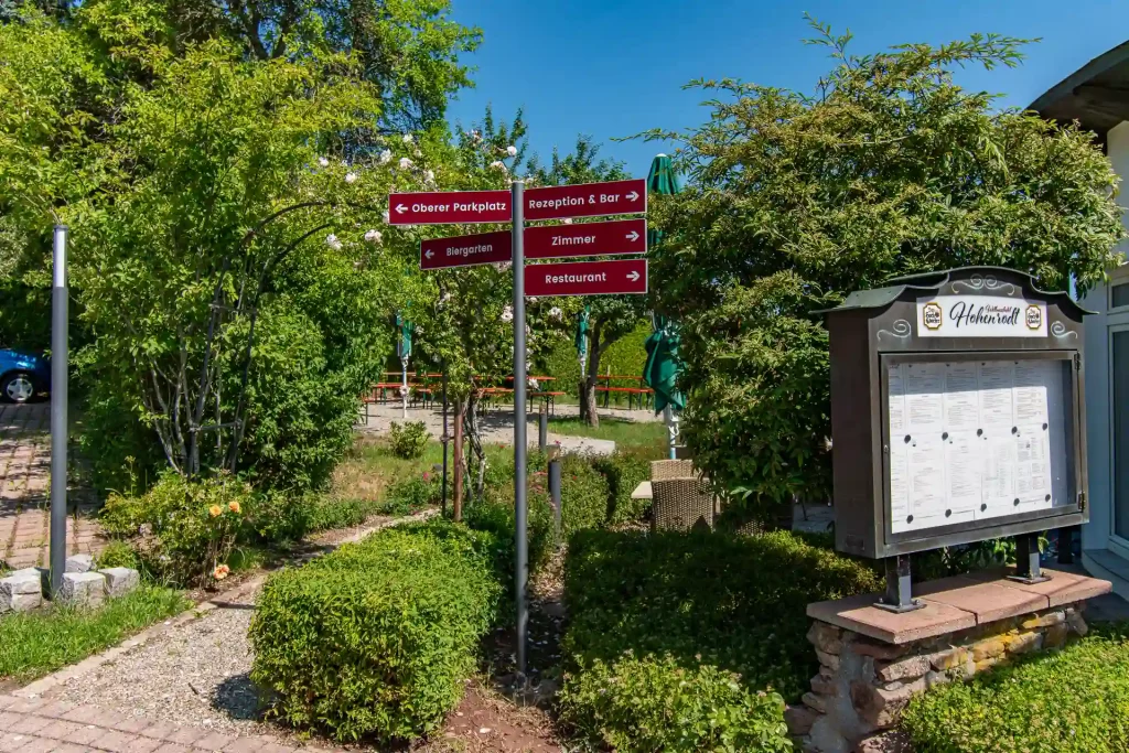 Beer garden entrance of the Wellnesshotel Hohenrodt with seating and green areas