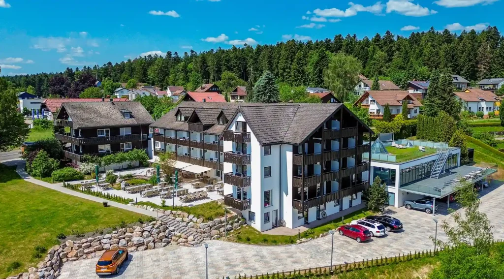 Aerial view of the Wellnesshotel Hohenrodt with hotel building, facade and outdoor parking