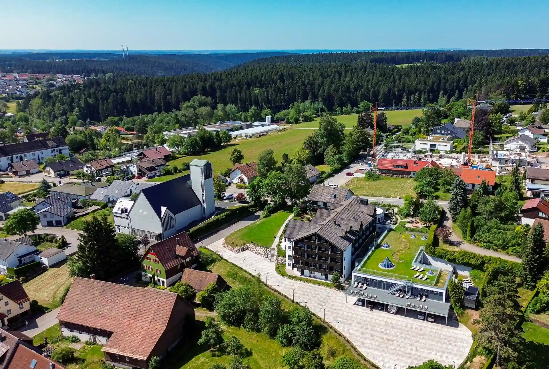 Aerial view of the Wellnesshotel Hohenrodt with hotel building, Black Forest and Kinzigquelle in the background