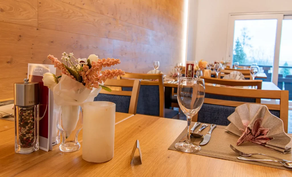 Modern restaurant area in the Wellnesshotel Hohenrodt with set table and stylish ambience