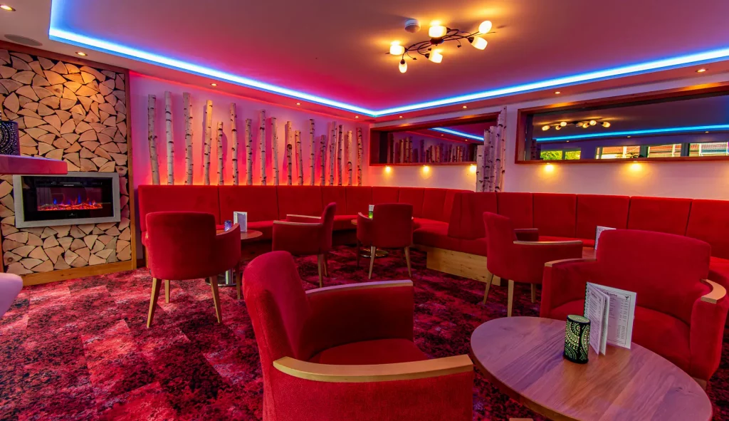 Reception and lounge in the Wellnesshotel Hohenrodt complete view with LED ambient lighting and cozy atmosphere