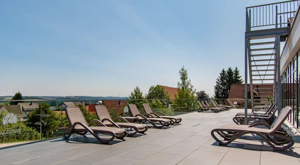 Outdoor balcony at Wellnesshotel Hohenrodt with a view and sunlight