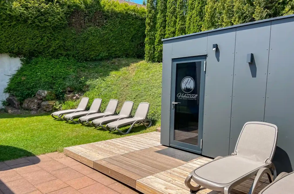 Outdoor area of Wellnesshotel Hohenrodt with outdoor sauna and private sun loungers in a quiet environment