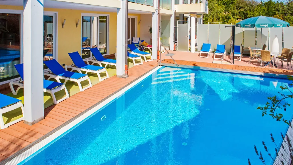Pool area of the Wellnesshotel Albblick with outdoor pool and sun loungers
